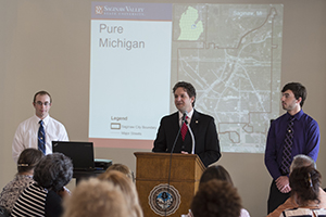 Andrew Miller, SVSU associate professor of geography, presents research showing blight removal in Saginaw has contributed a drop in crime in the city and its neighbors. Miller spoke at the Reinventing Saginaw symposium at the Bancroft building in downtown Saginaw May 26, 2015.